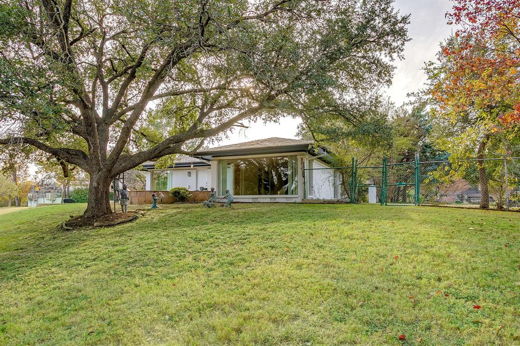4301 Briarhaven Road Fort Worth, TX 76109 - Photo 21 of 40 a front view of a house with a garden