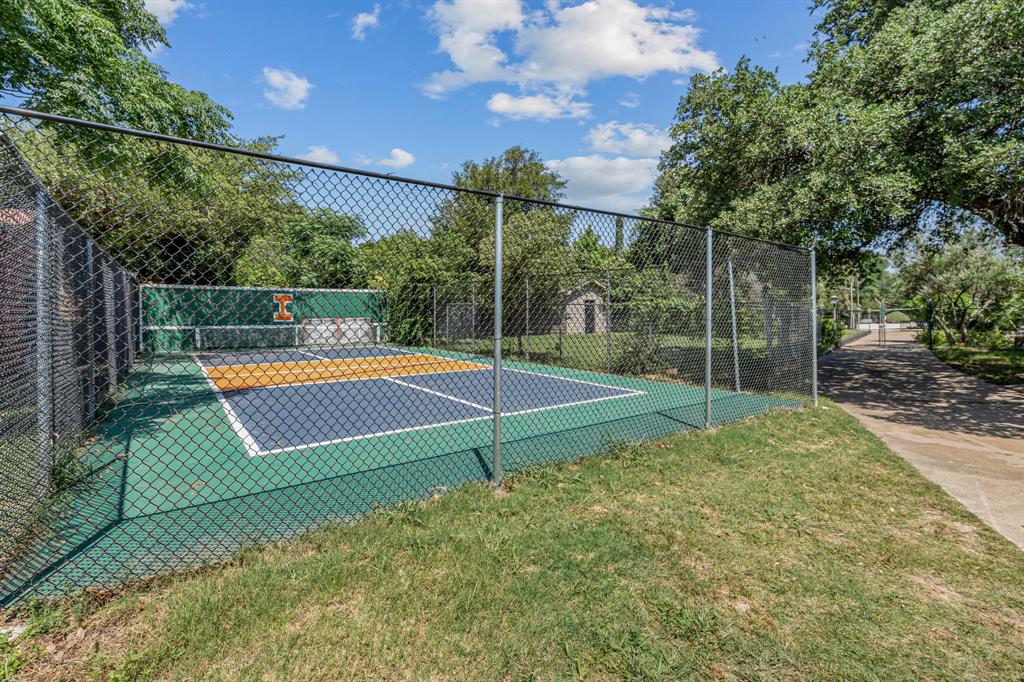 4301 Briarhaven Road Fort Worth, TX 76109 - Photo 25 of 40 a view of a tennis ground with large trees