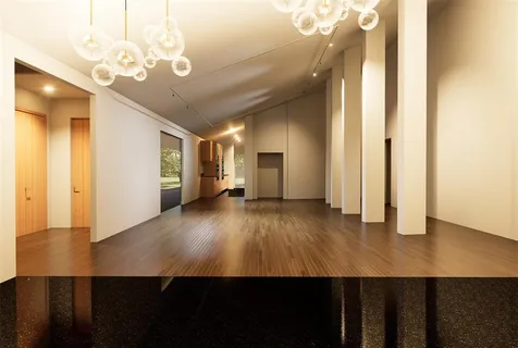 a large kitchen with stainless steel appliances a large counter top and wooden floors