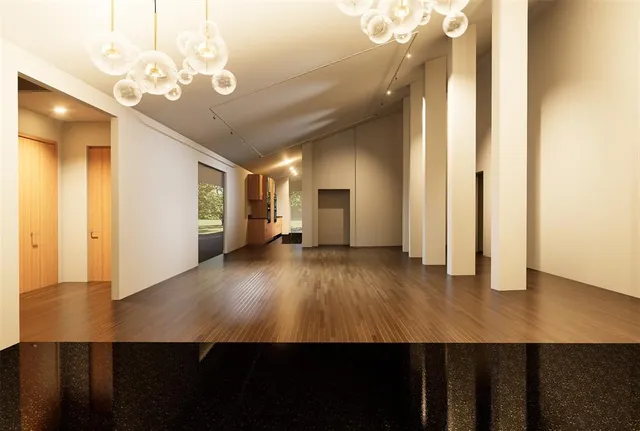 a large kitchen with stainless steel appliances a large counter top and wooden floors