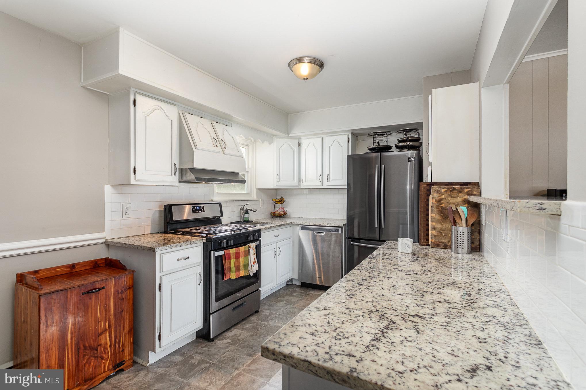 831 Erford Road Camp Hill, PA 17011 - Photo 11 of 36 a kitchen with stainless steel appliances granite countertop a stove top oven a refrigerator a sink and dishwasher