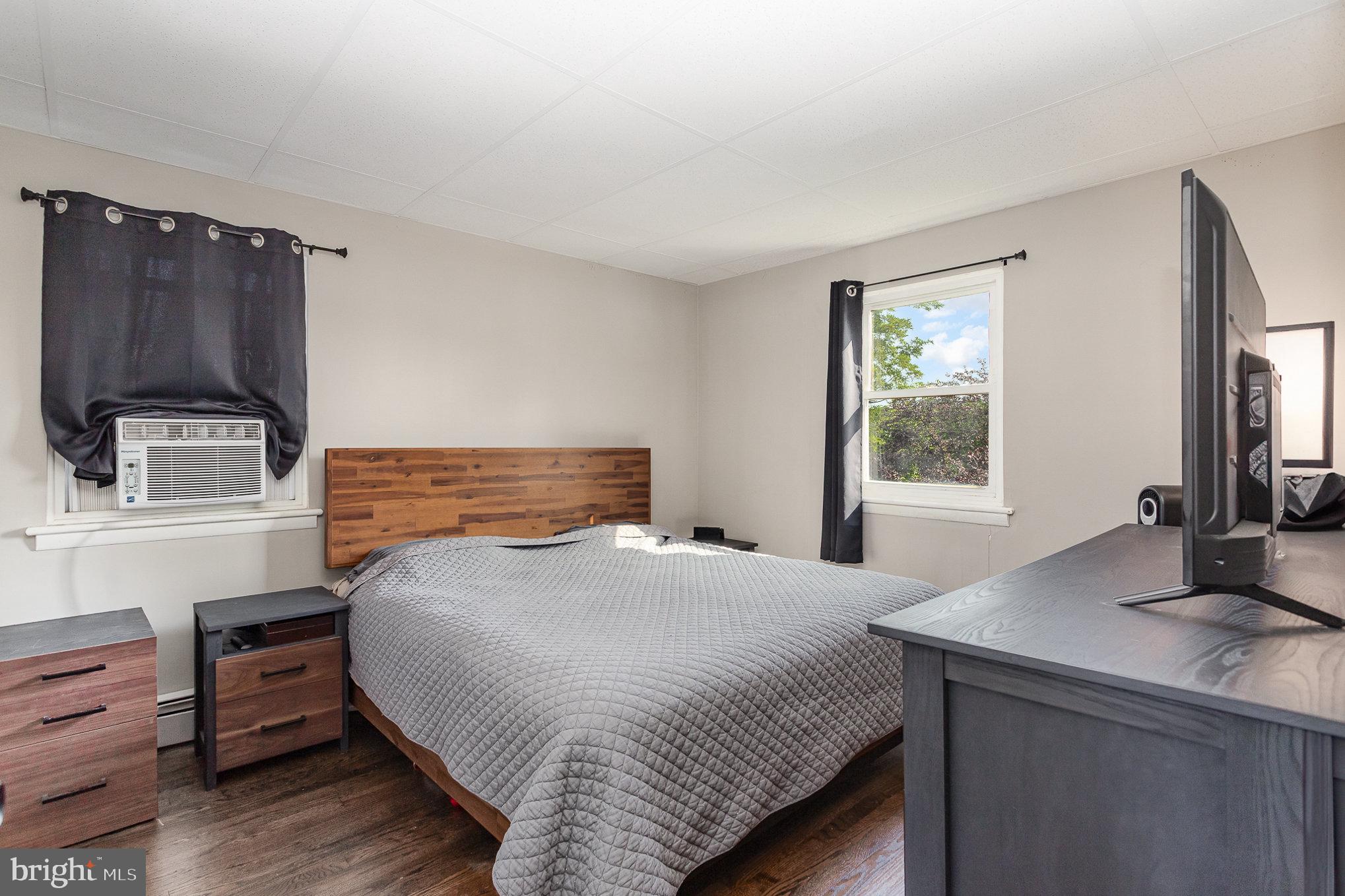 831 Erford Road Camp Hill, PA 17011 - Photo 15 of 36 a bedroom with a bed and a flat screen tv