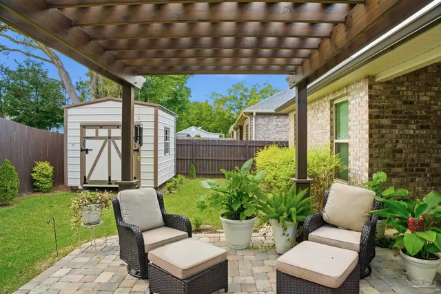 a view of a chairs and table in backyard of the house