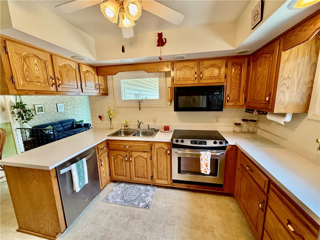 114 Columbus Drive Decatur, IL 62526 - Photo 6 of 29 a kitchen with stainless steel appliances granite countertop a stove a sink and a microwave