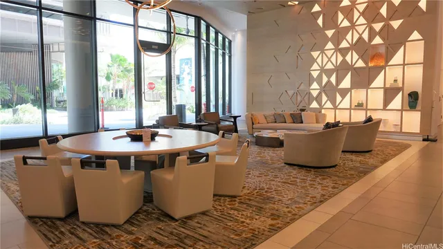 a living room with large window and furniture