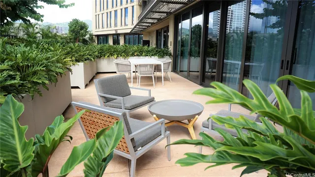 a view of a patio with a table and chairs