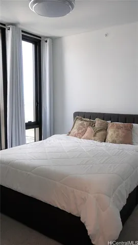 a bedroom with a bed and window