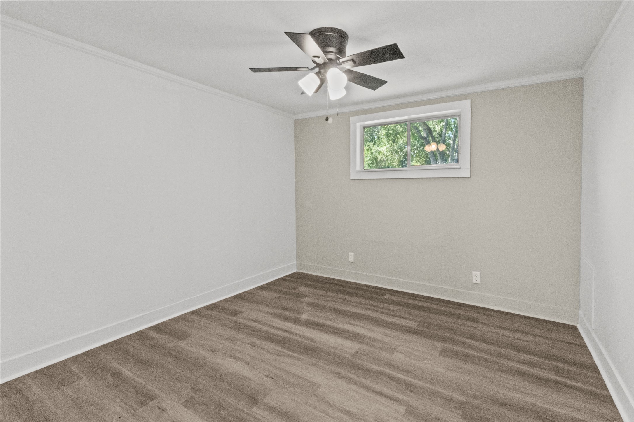 802 Collins Street Dayton, TX 77535 - Photo 5 of 12 a view of an empty room with a window