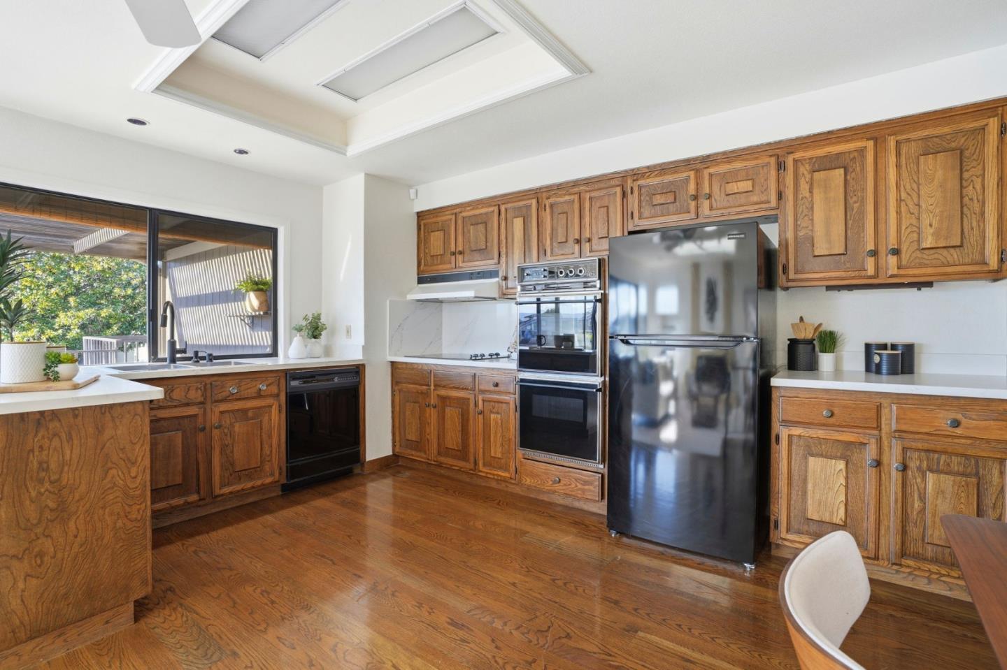 1190 Flying Fish Street Foster City, CA 94404 - Photo 11 of 45 a kitchen with stainless steel appliances a refrigerator sink and stove