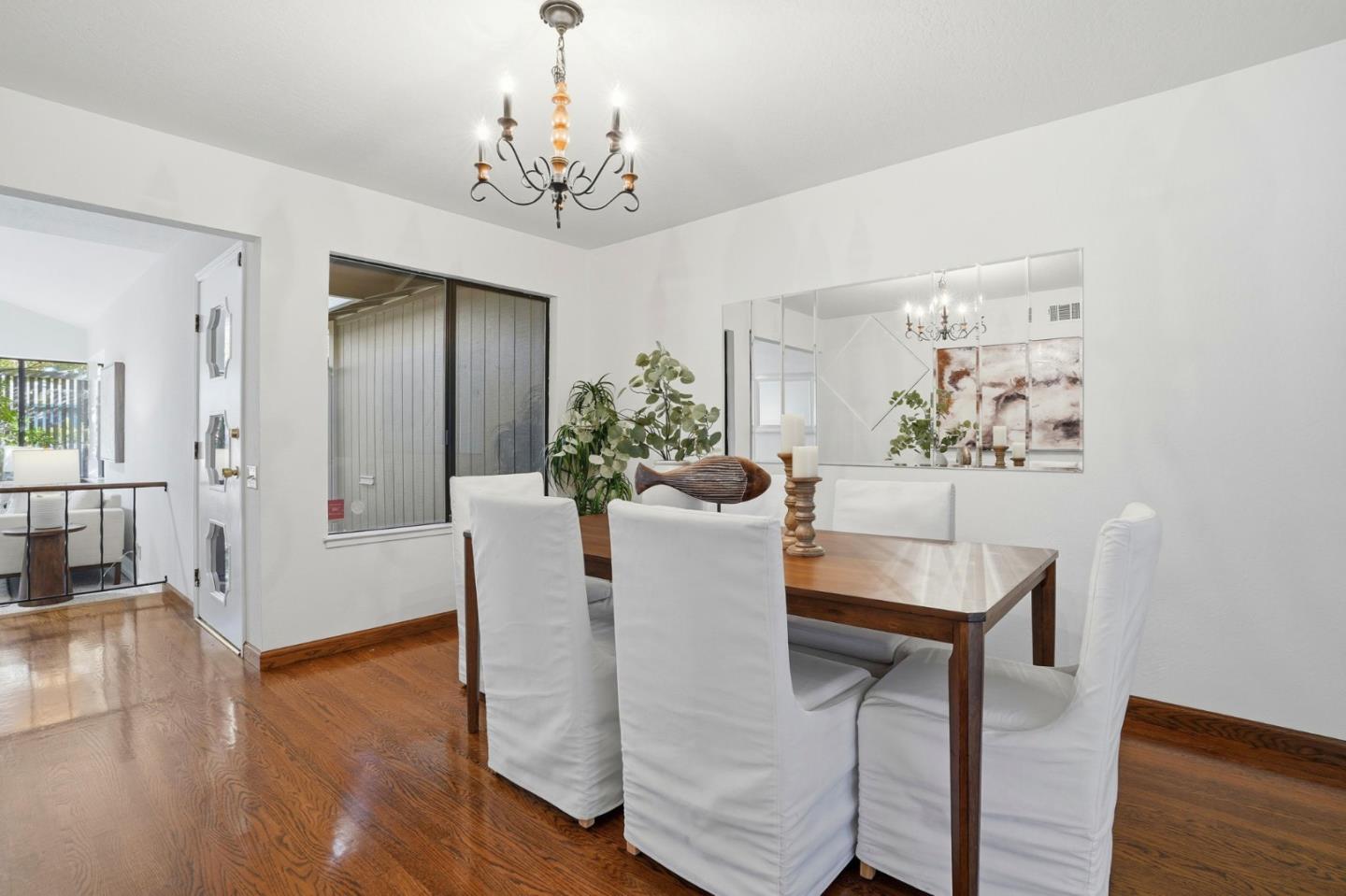 1190 Flying Fish Street Foster City, CA 94404 - Photo 16 of 45 a view of a dining room with furniture wooden floor and a chandelier