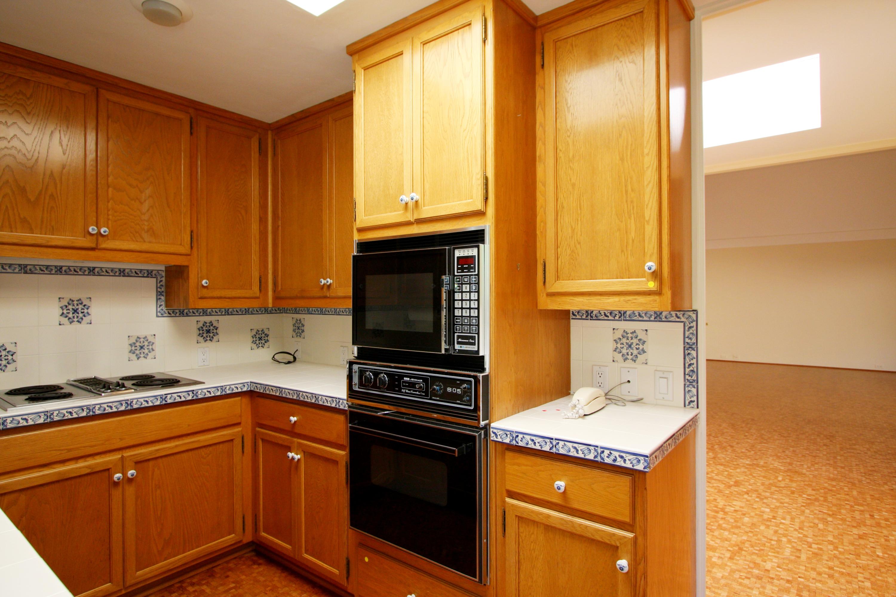 532 San Ysidro Road Santa Barbara, CA 93108 - Photo 4 of 10 a kitchen with granite countertop cabinets stainless steel appliances a sink and a window