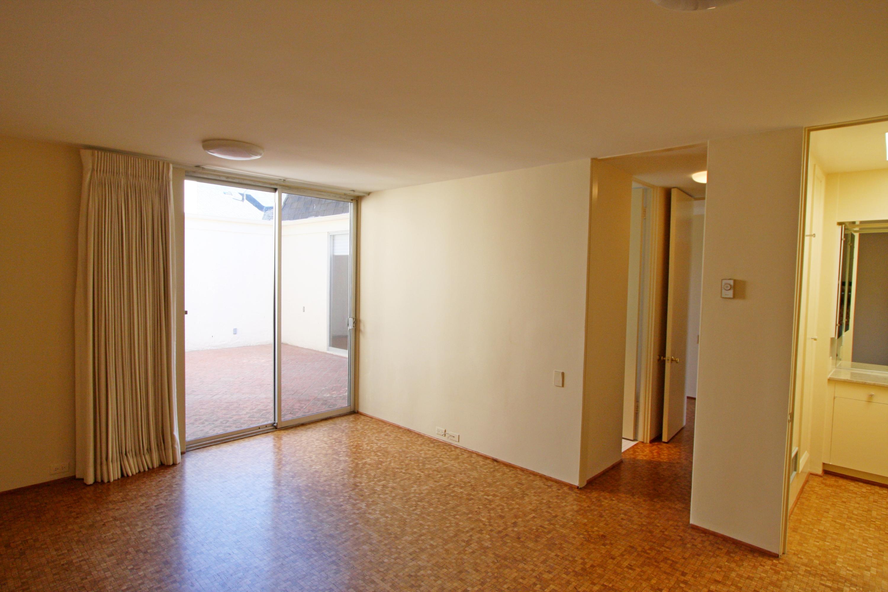 532 San Ysidro Road Santa Barbara, CA 93108 - Photo 7 of 10 a view of an empty room with wooden floor and a window