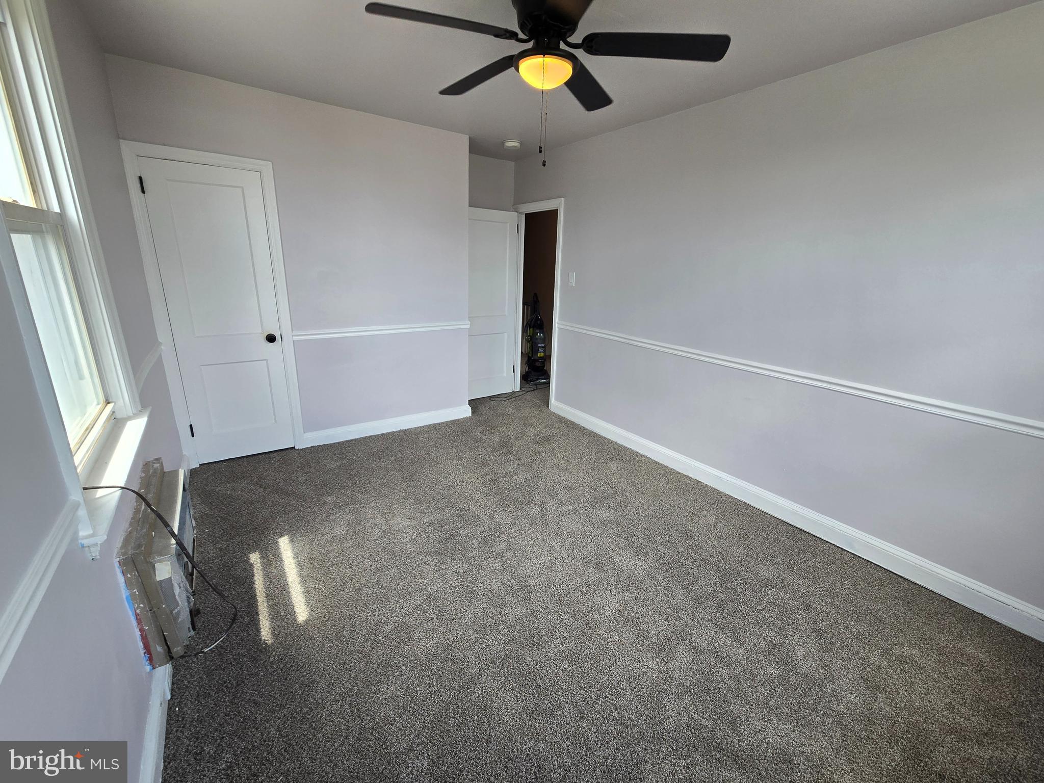 201 St Laurence Road Upper Darby, PA 19082 - Photo 32 of 37 an empty room with a ceiling fan and window