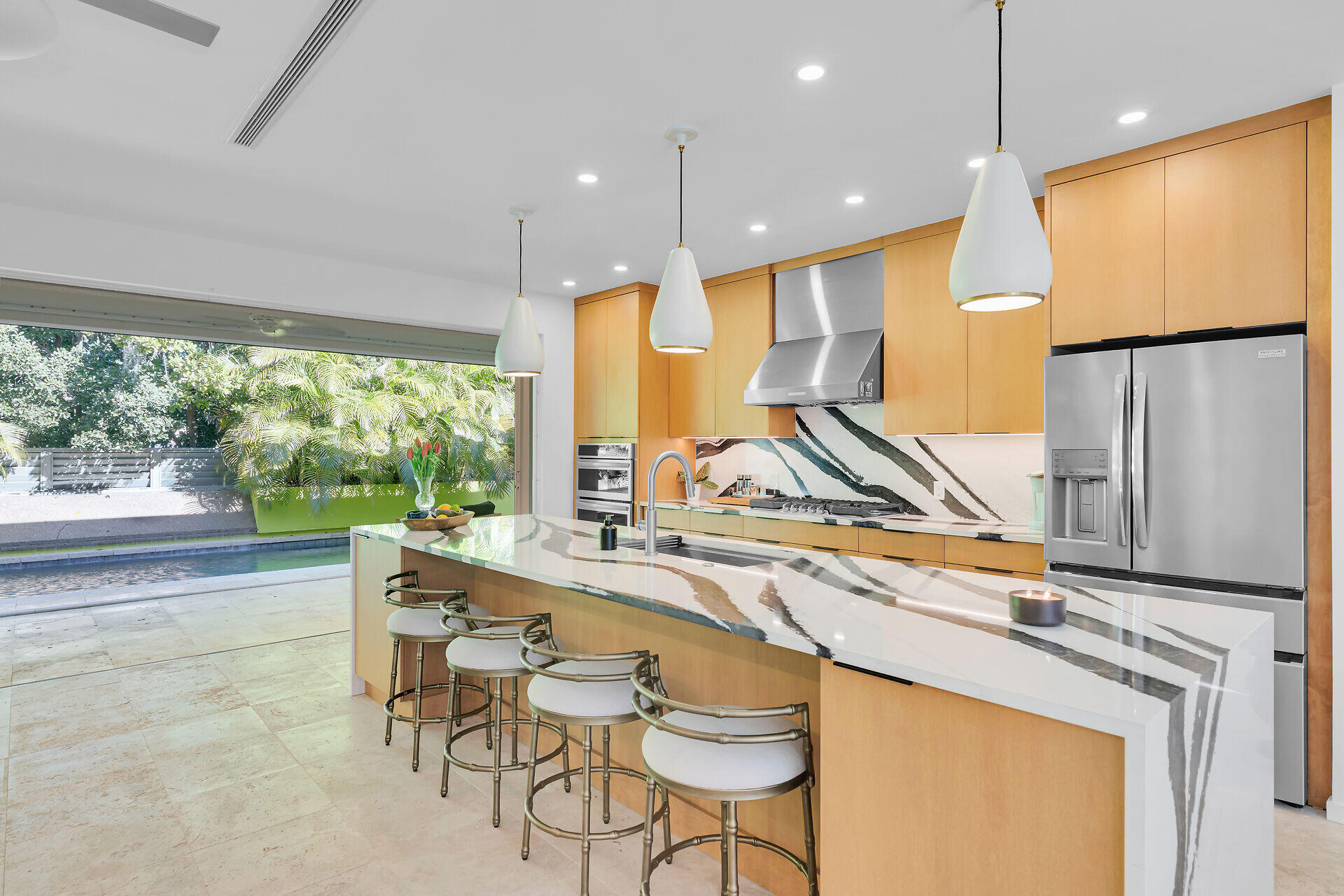 1501 Georgia Street Key West, FL 33040 - Photo 11 of 50 a view of a kitchen with kitchen island a large window cabinets a sink and stainless steel appliances