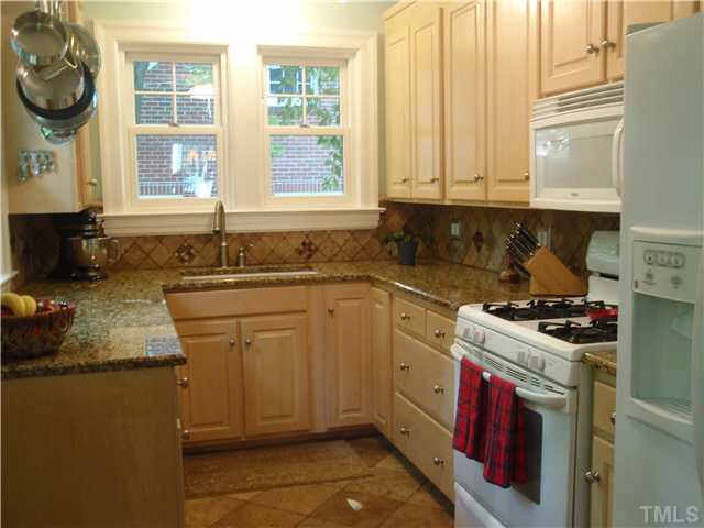 304 Brooks Avenue Raleigh, NC 27607 - Photo 6 of 14 New cabinets and granite counter top. Gas range. Marble flooring. Kitchen