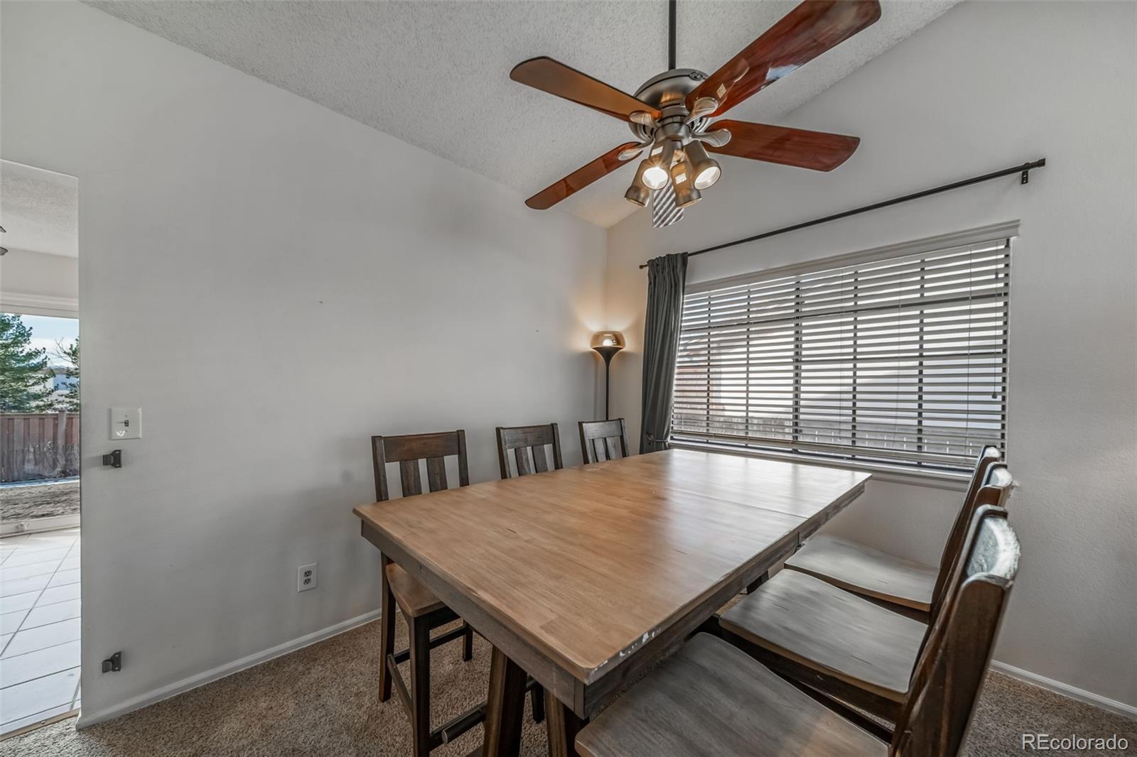 9240 Stargrass Circle Highlands Ranch, CO 80126 - Photo 11 of 46 a view of a dining room with furniture and a chandelier