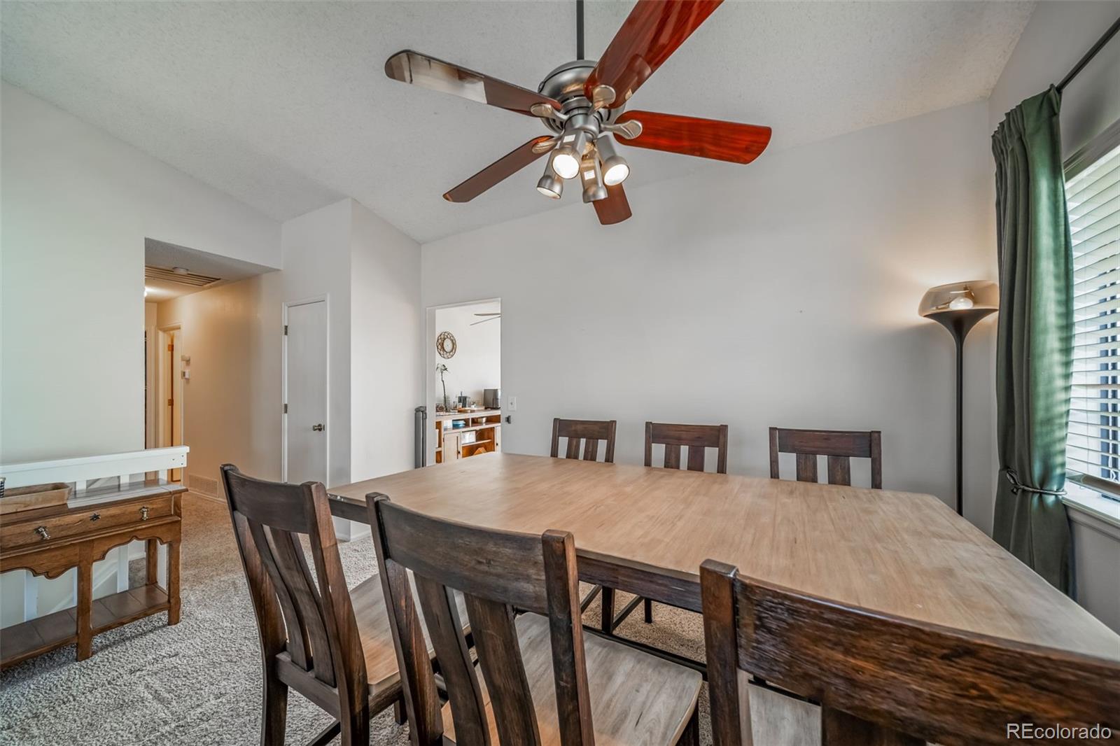9240 Stargrass Circle Highlands Ranch, CO 80126 - Photo 13 of 46 a view of a dining room with furniture and a chandelier