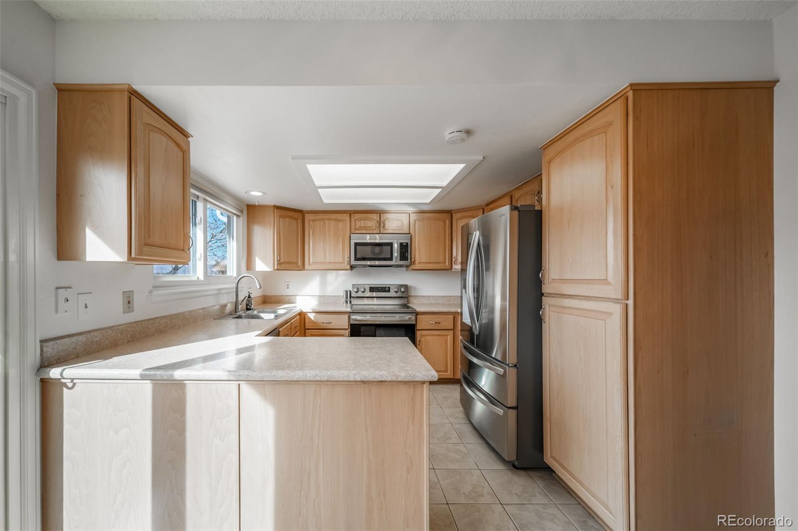 9240 Stargrass Circle Highlands Ranch, CO 80126 - Photo 16 of 46 a kitchen with stainless steel appliances a refrigerator sink and stove
