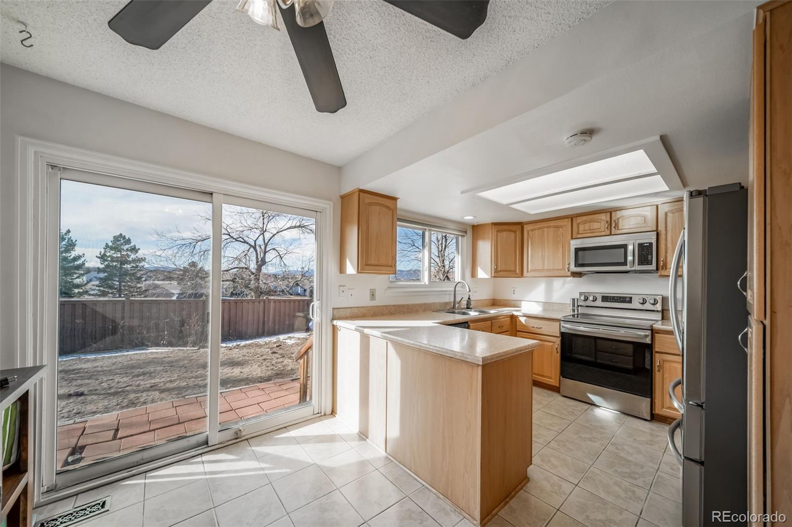 9240 Stargrass Circle Highlands Ranch, CO 80126 - Photo 17 of 46 a kitchen with stainless steel appliances granite countertop a stove a sink and a refrigerator