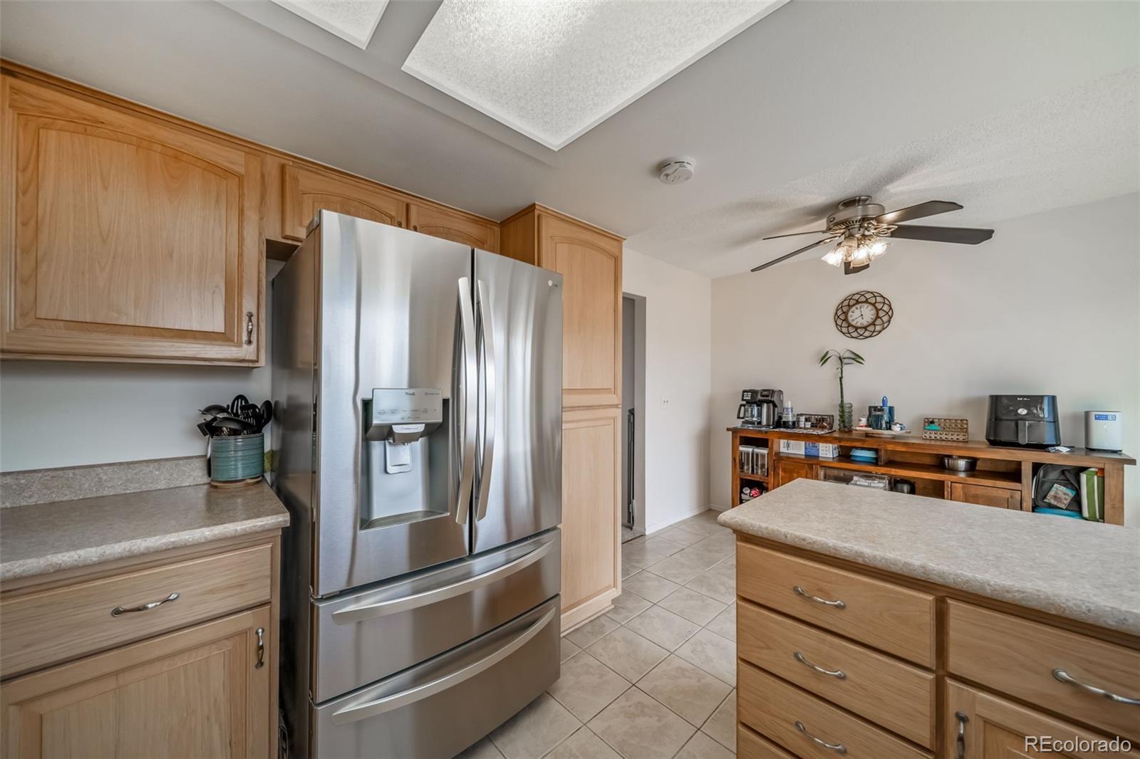 9240 Stargrass Circle Highlands Ranch, CO 80126 - Photo 19 of 46 a kitchen with a refrigerator and a sink