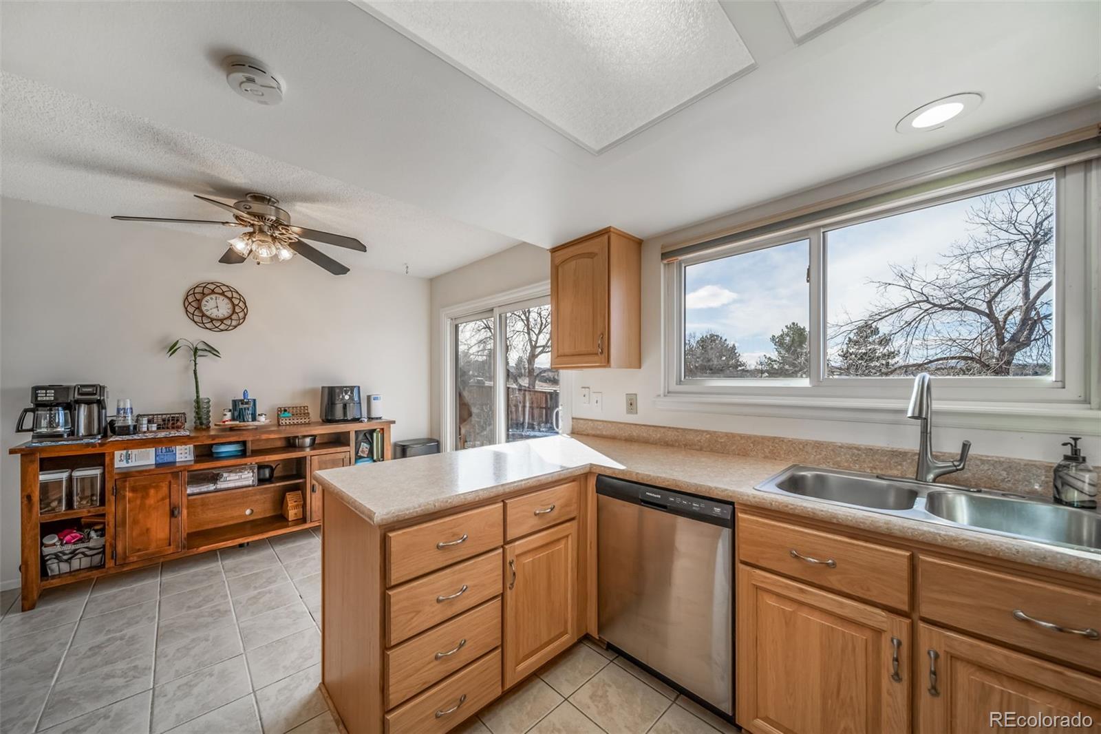 9240 Stargrass Circle Highlands Ranch, CO 80126 - Photo 20 of 46 a kitchen with stainless steel appliances granite countertop a sink stove and refrigerator