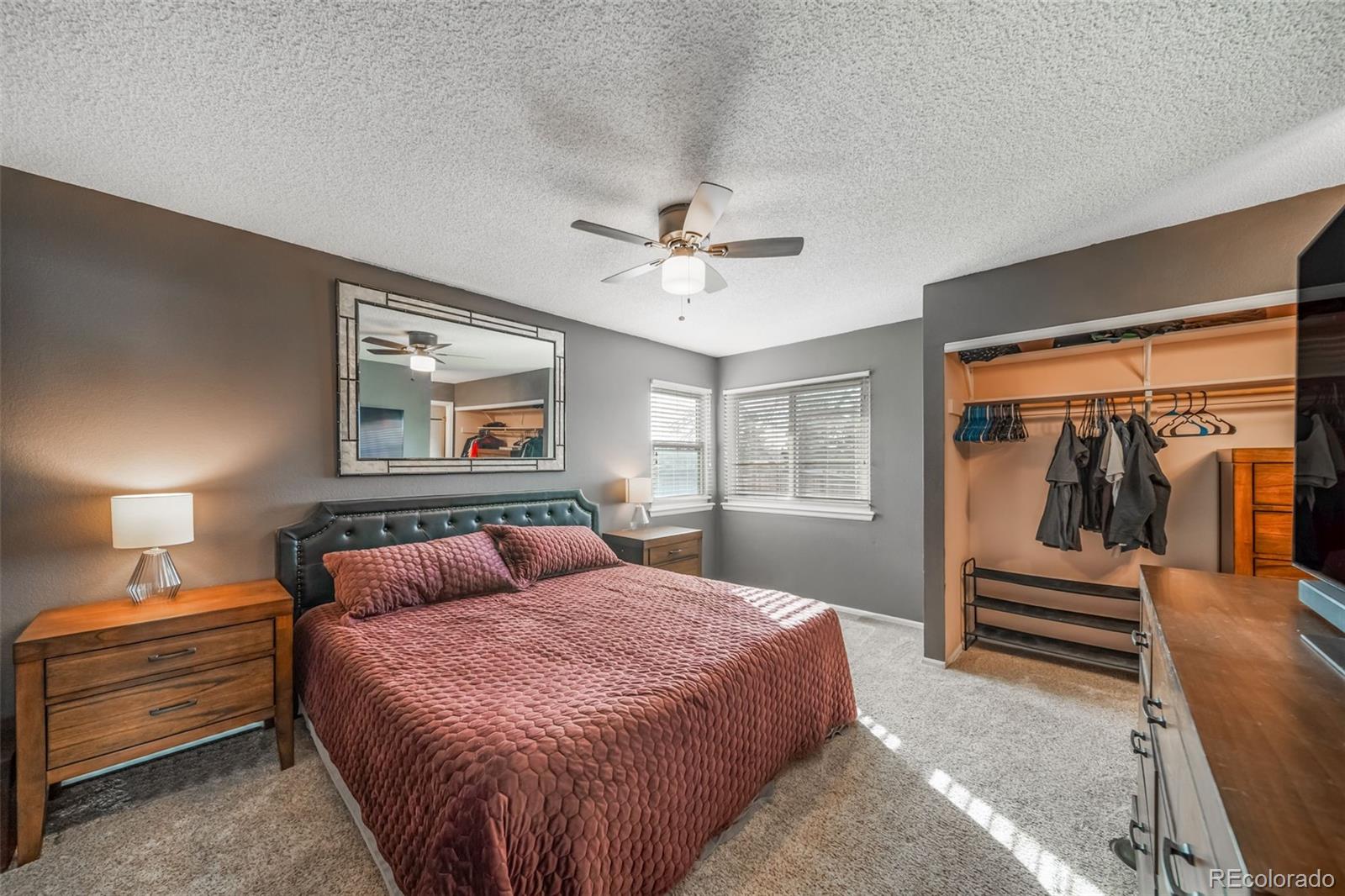 9240 Stargrass Circle Highlands Ranch, CO 80126 - Photo 21 of 46 a bedroom with a bed and a chandelier