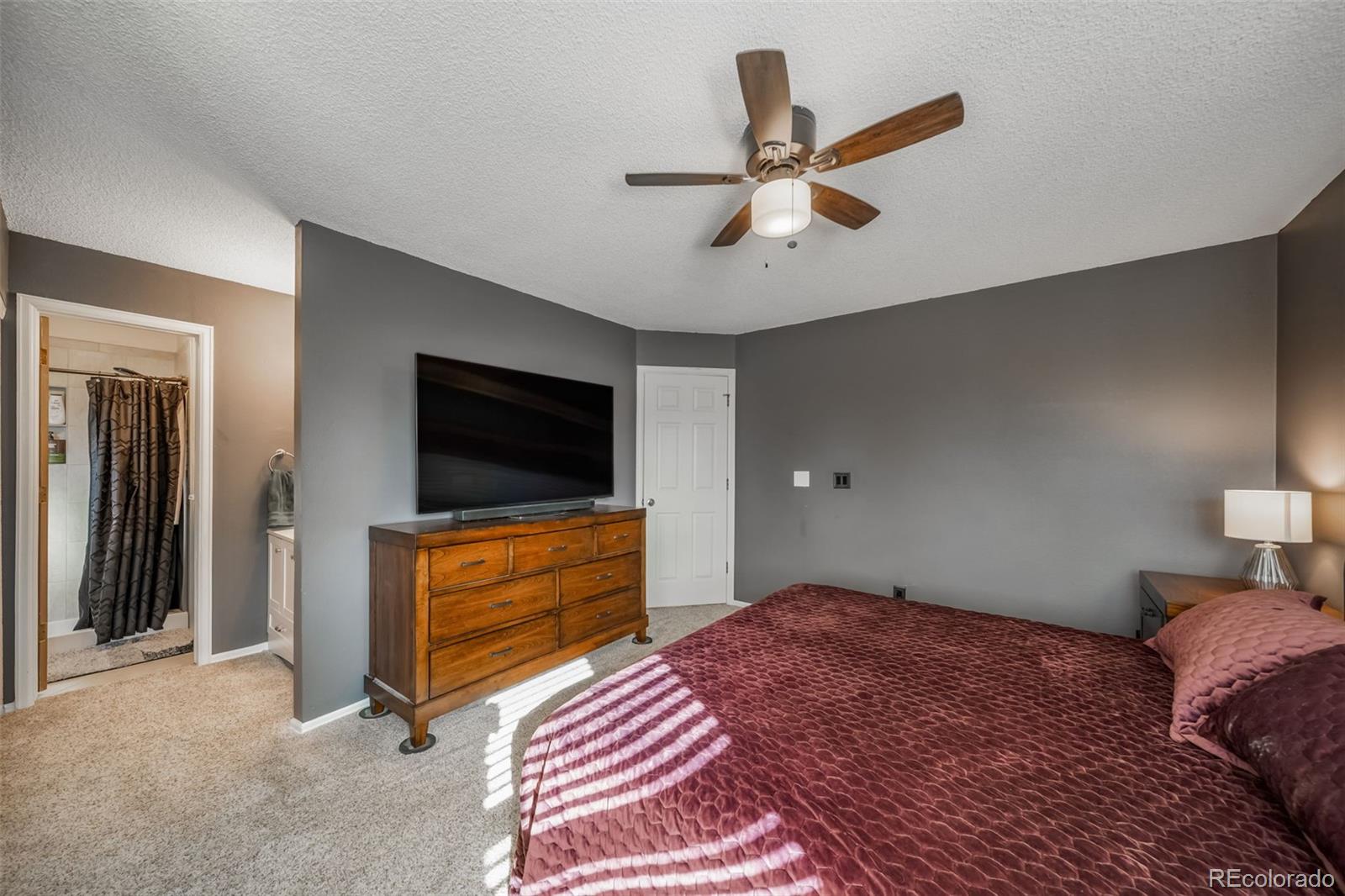 9240 Stargrass Circle Highlands Ranch, CO 80126 - Photo 23 of 46 a bedroom with a bed and a flat screen tv
