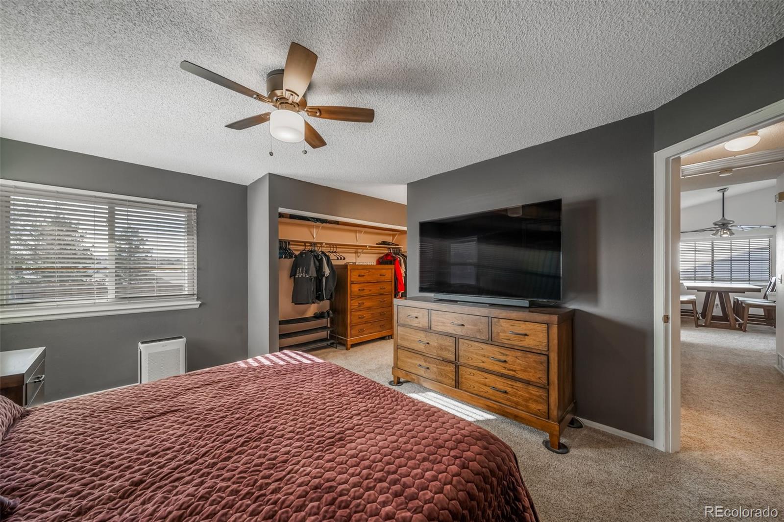 9240 Stargrass Circle Highlands Ranch, CO 80126 - Photo 24 of 46 a bedroom with a bed and a flat screen tv