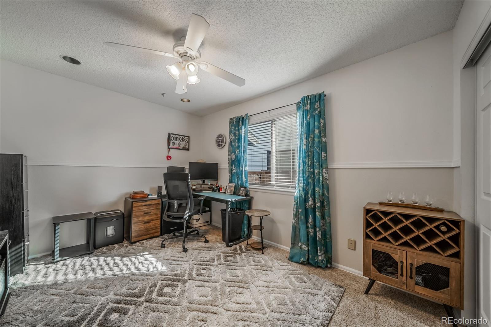 9240 Stargrass Circle Highlands Ranch, CO 80126 - Photo 30 of 46 a workspace with furniture wooden floor and a rug