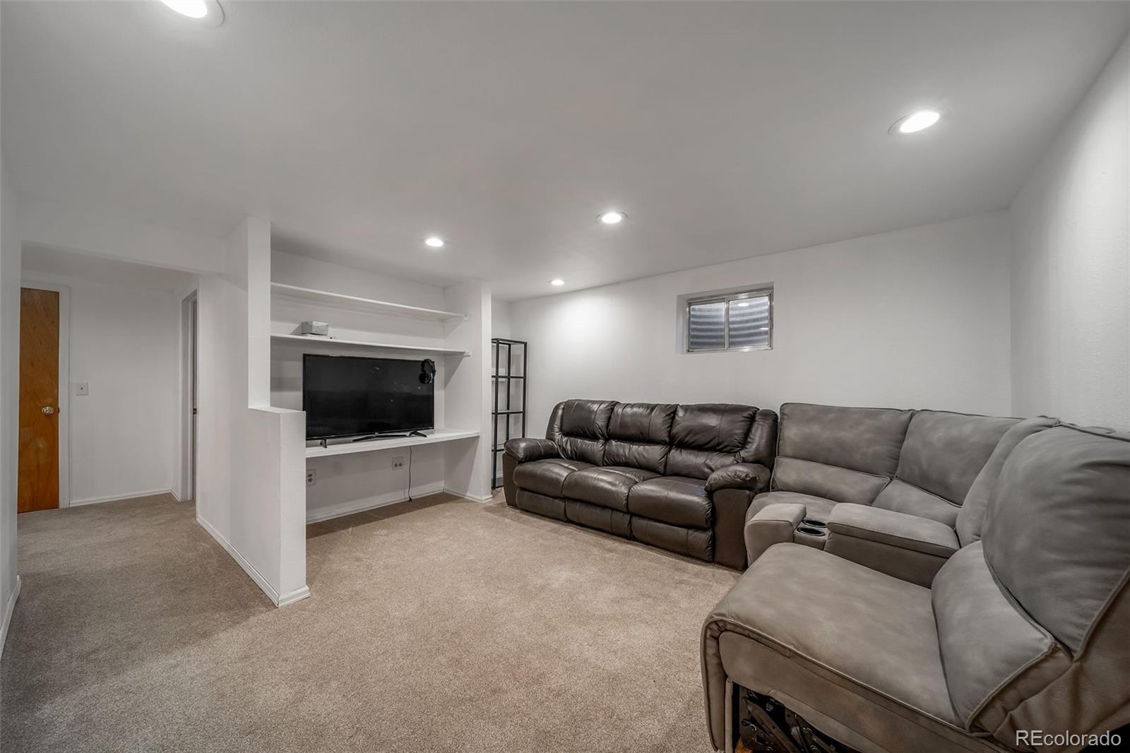 9240 Stargrass Circle Highlands Ranch, CO 80126 - Photo 33 of 46 a living room with furniture and a flat screen tv