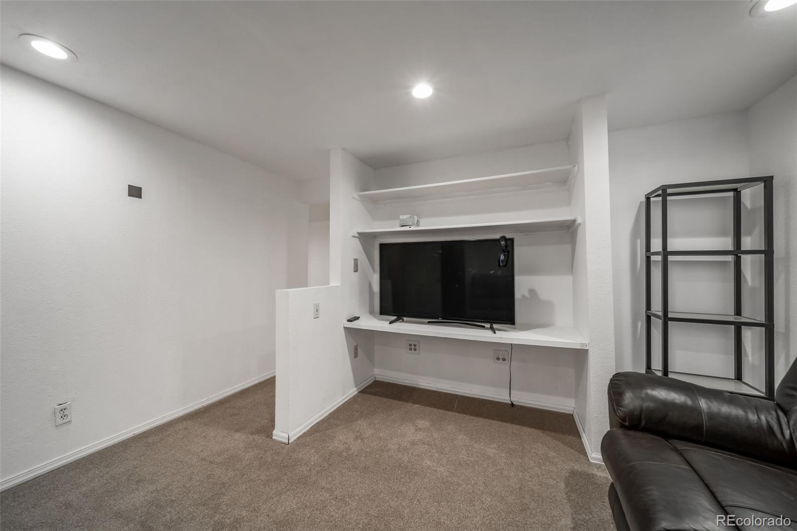 9240 Stargrass Circle Highlands Ranch, CO 80126 - Photo 34 of 46 a living room with furniture and a flat screen tv