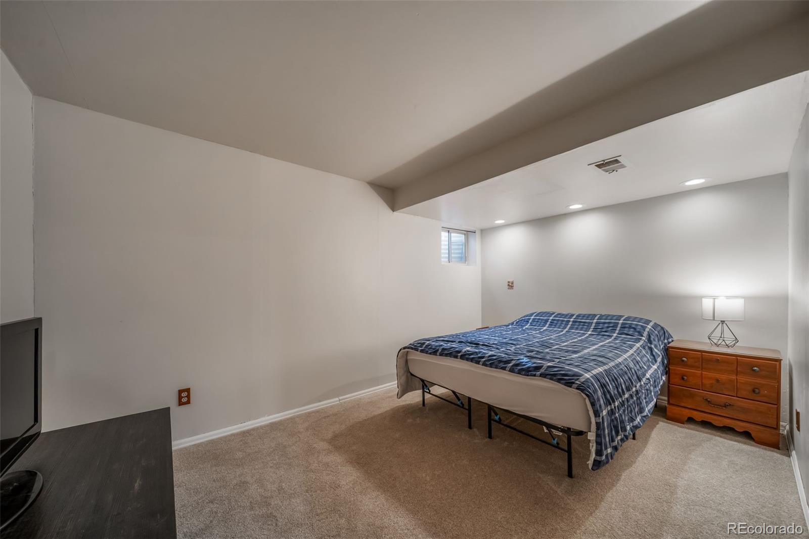 9240 Stargrass Circle Highlands Ranch, CO 80126 - Photo 37 of 46 a spacious bedroom with a bed and a dresser in it