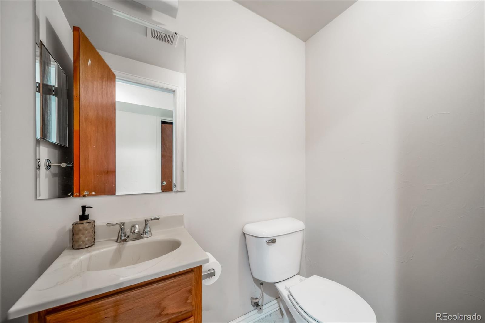 9240 Stargrass Circle Highlands Ranch, CO 80126 - Photo 39 of 46 a bathroom with a toilet sink and mirror