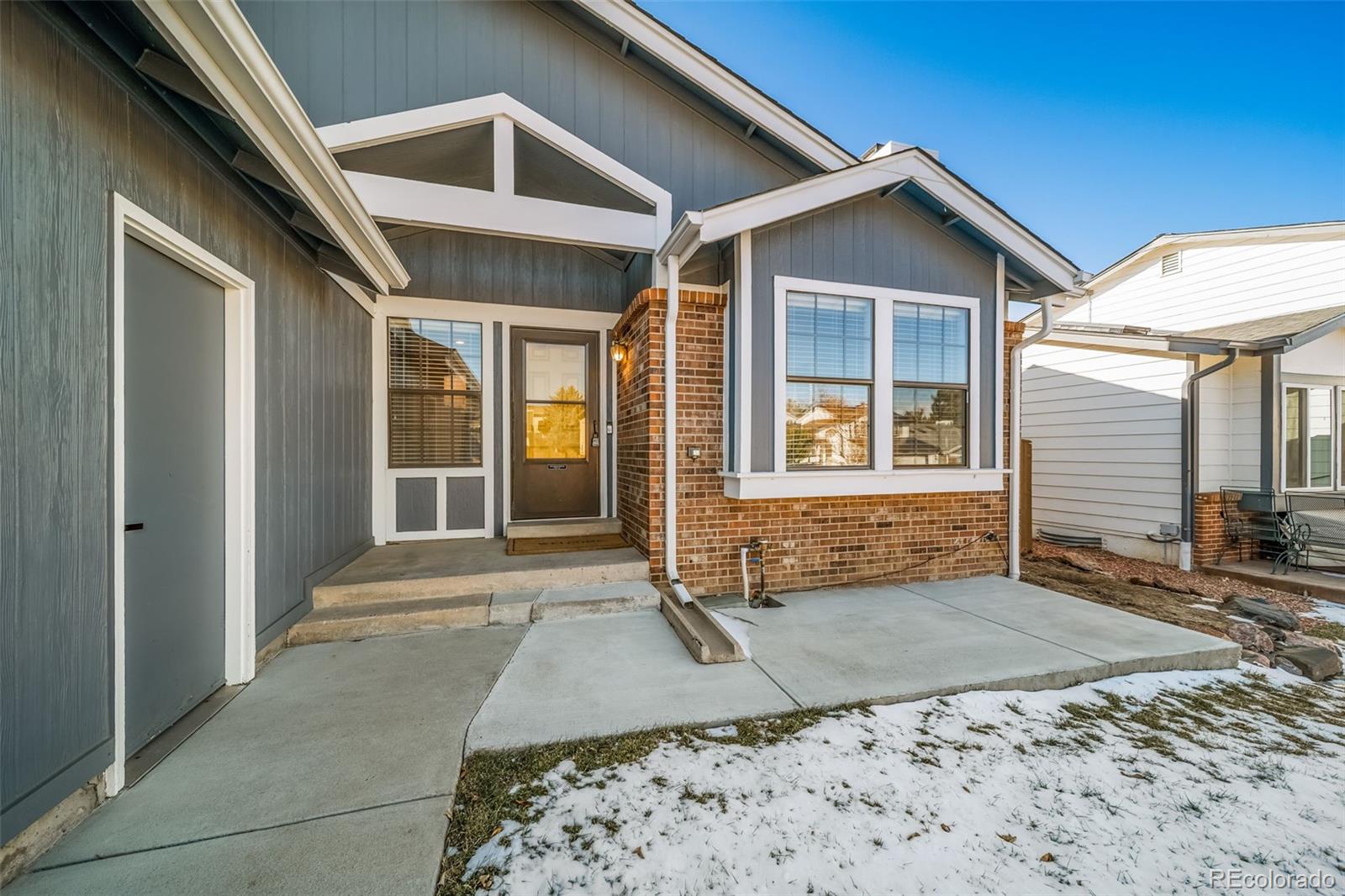 9240 Stargrass Circle Highlands Ranch, CO 80126 - Photo 4 of 46 a front view of a house with a yard