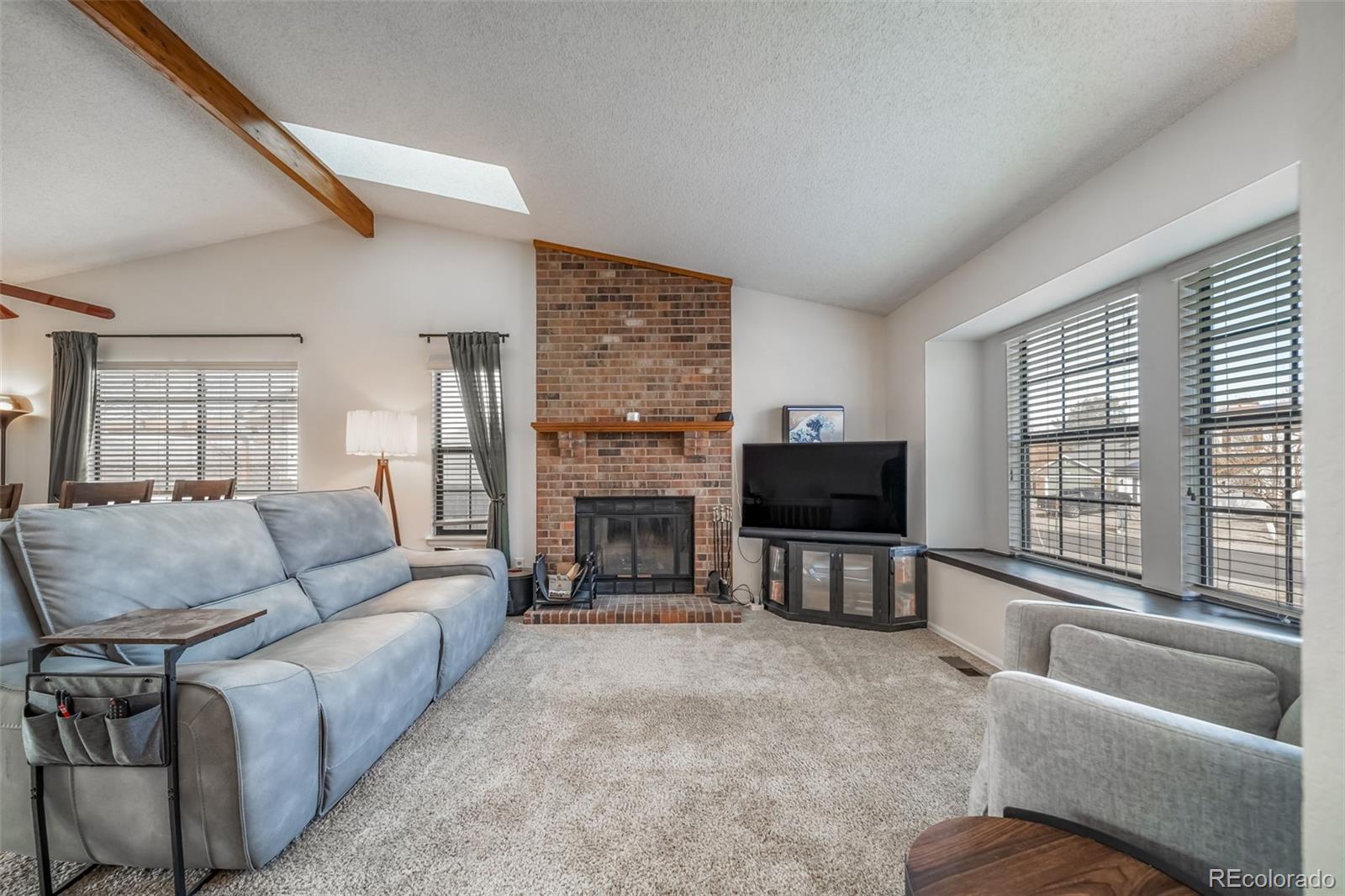 9240 Stargrass Circle Highlands Ranch, CO 80126 - Photo 6 of 46 a living room with fireplace furniture and a flat screen tv