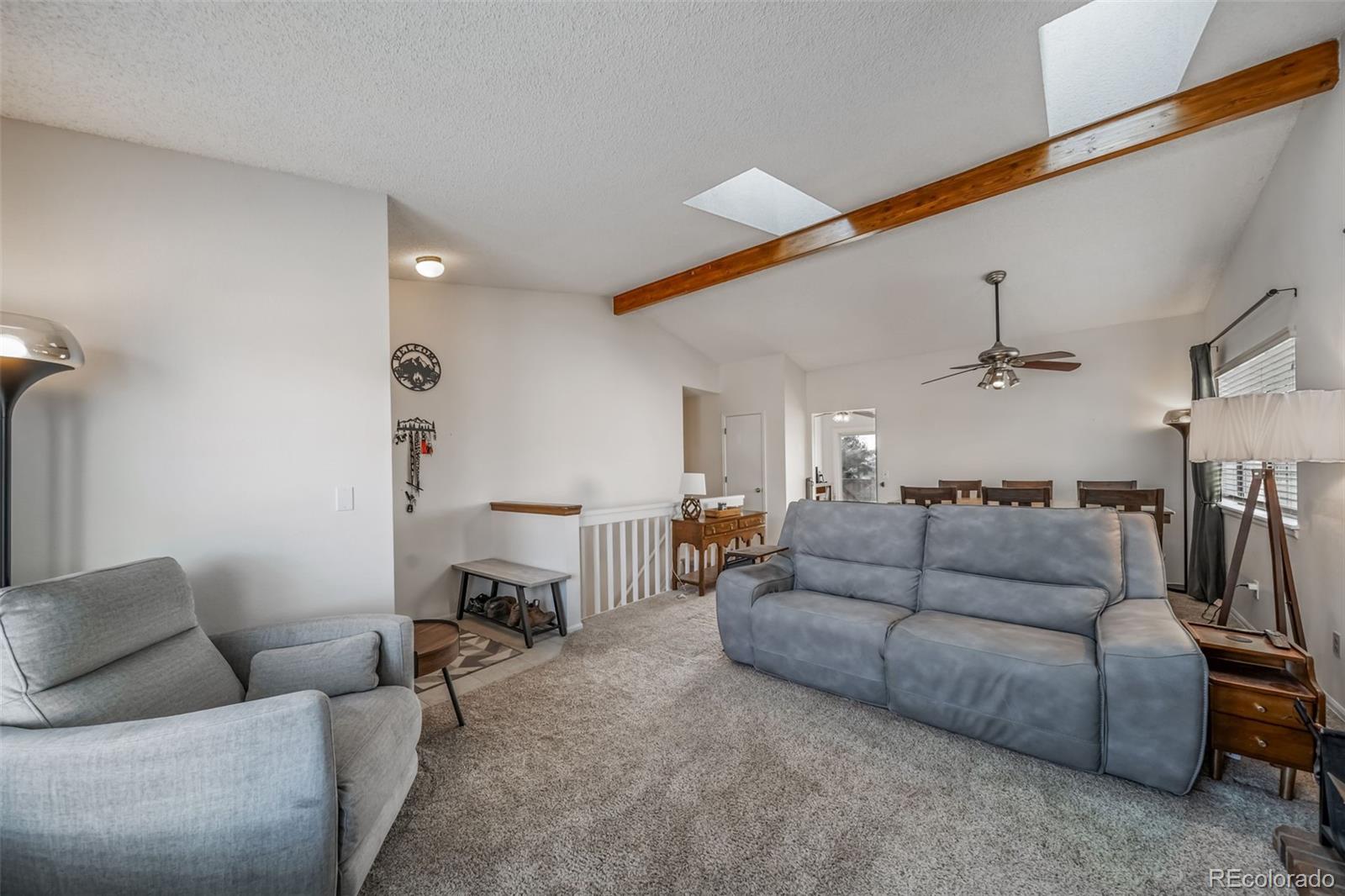 9240 Stargrass Circle Highlands Ranch, CO 80126 - Photo 9 of 46 a living room with furniture and a ceiling fan