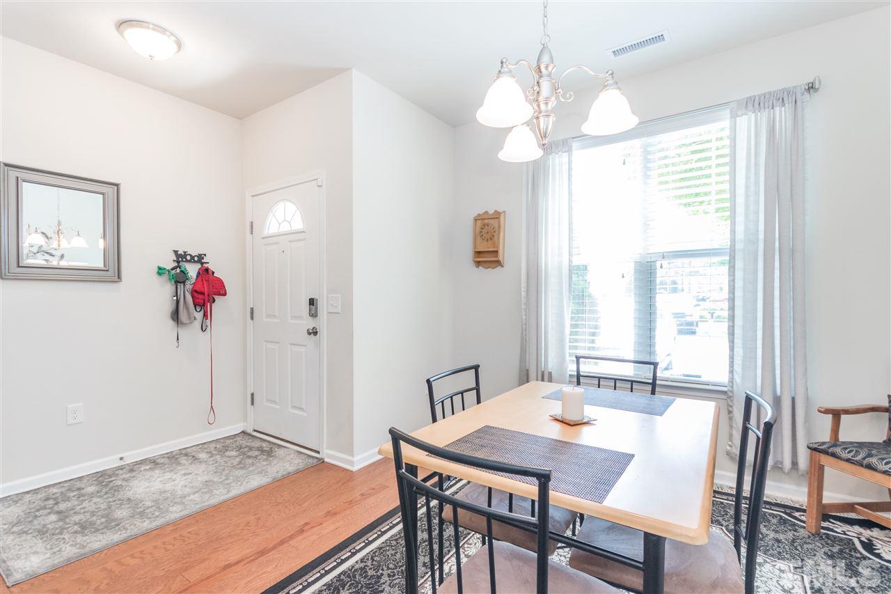 2960 Berkeley Springs Place Raleigh, NC 27616 - Photo 2 of 14 a view of a dining room with furniture and wooden floor