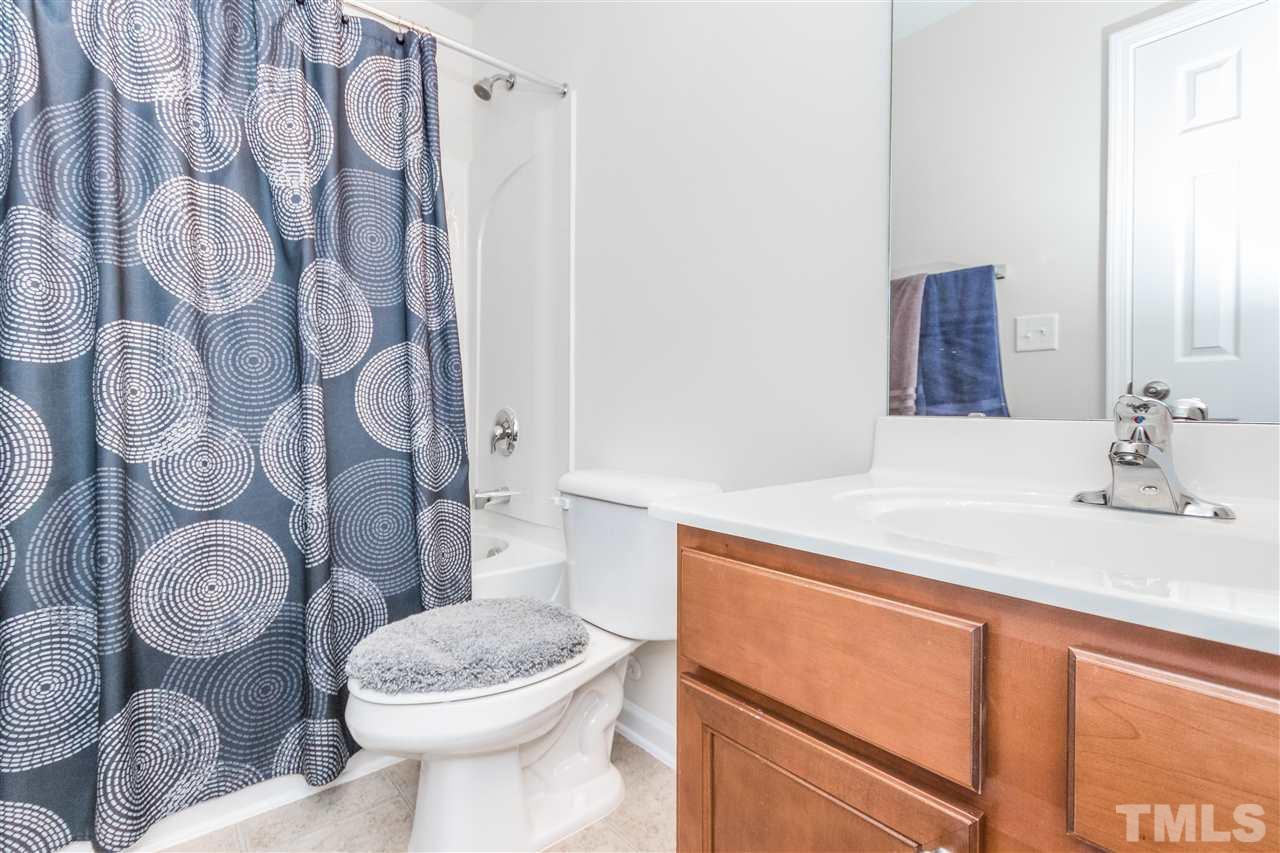 2960 Berkeley Springs Place Raleigh, NC 27616 - Photo 11 of 14 a bathroom with a granite countertop toilet sink and mirror