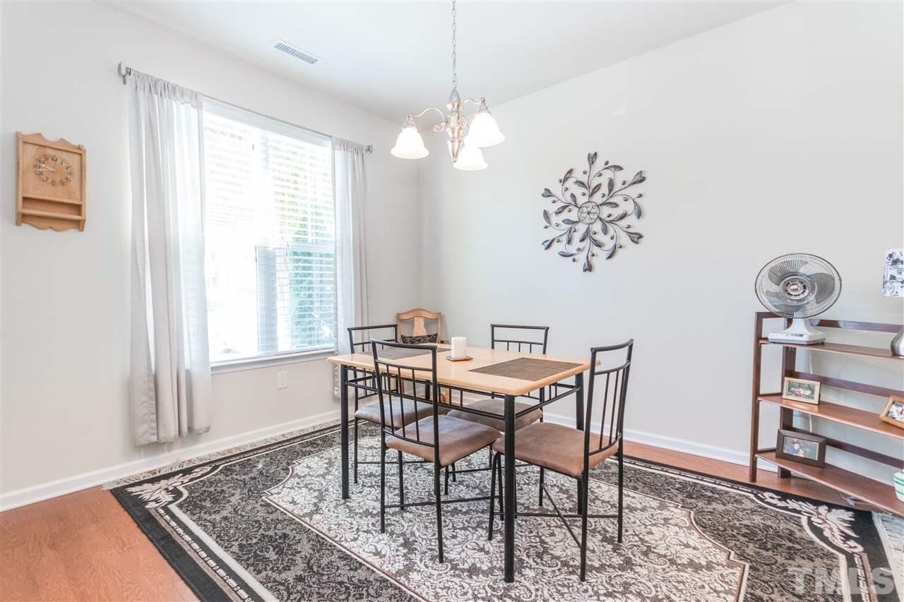 2960 Berkeley Springs Place Raleigh, NC 27616 - Photo 3 of 14 a view of a dining room with furniture window and wooden floor