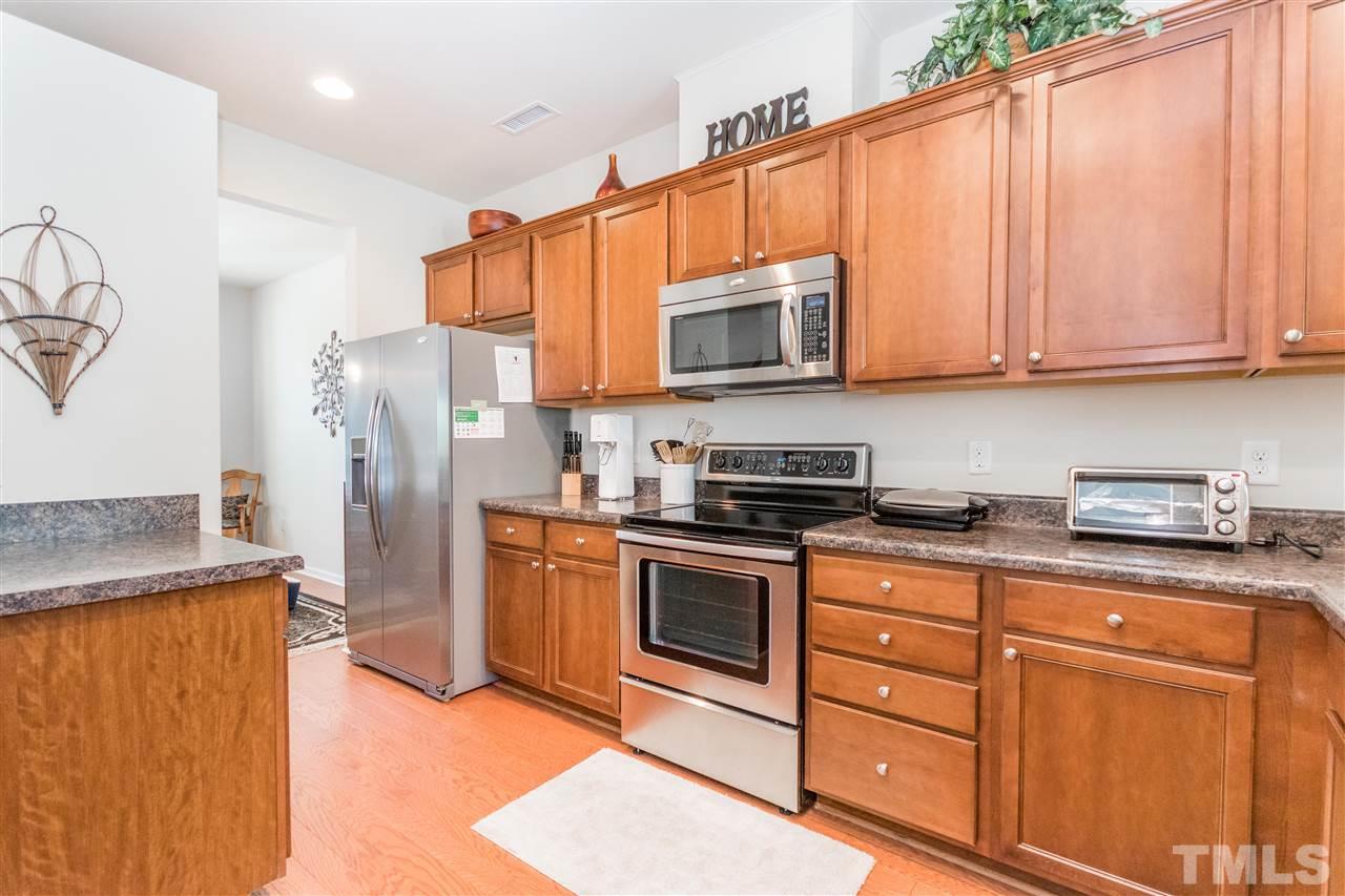 2960 Berkeley Springs Place Raleigh, NC 27616 - Photo 7 of 14 a kitchen with stainless steel appliances granite countertop a refrigerator stove and microwave