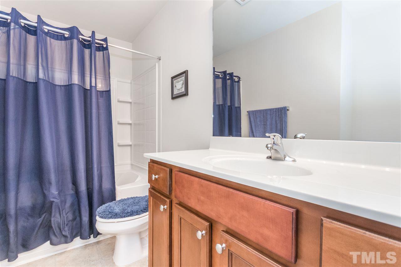 2960 Berkeley Springs Place Raleigh, NC 27616 - Photo 9 of 14 a bathroom with a sink a toilet and shower