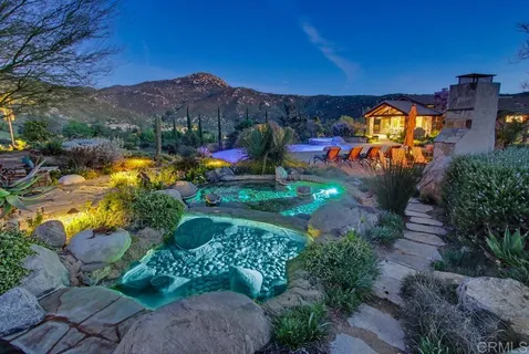 a front view of a house with a fountain