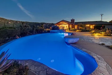 a view of a dining room with furniture large windows and wooden floor