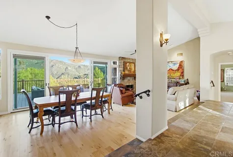 a kitchen with stainless steel appliances granite countertop a sink a stove cabinets and living room view