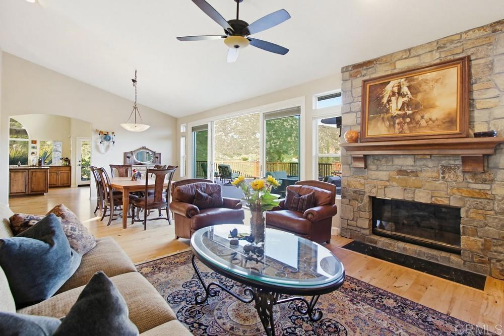 3930 Via Palo Verde Lago Alpine, CA 91901 - Photo 21 of 75 a living room with furniture a window and a fireplace