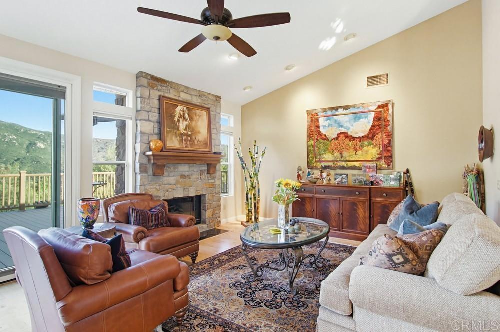 3930 Via Palo Verde Lago Alpine, CA 91901 - Photo 22 of 75 a living room with furniture and a fireplace