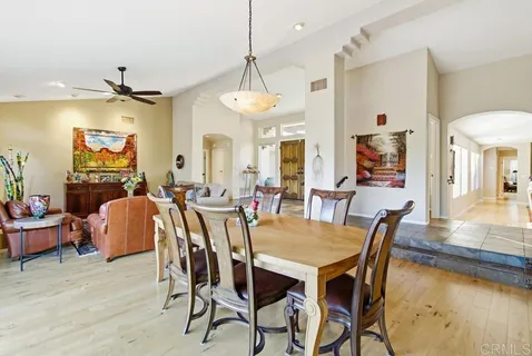 a spacious bedroom with a bed and glass window