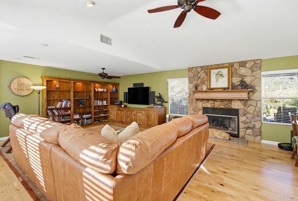 3930 Via Palo Verde Lago Alpine, CA 91901 - Photo 27 of 75 a living room with furniture a fireplace and a flat screen tv