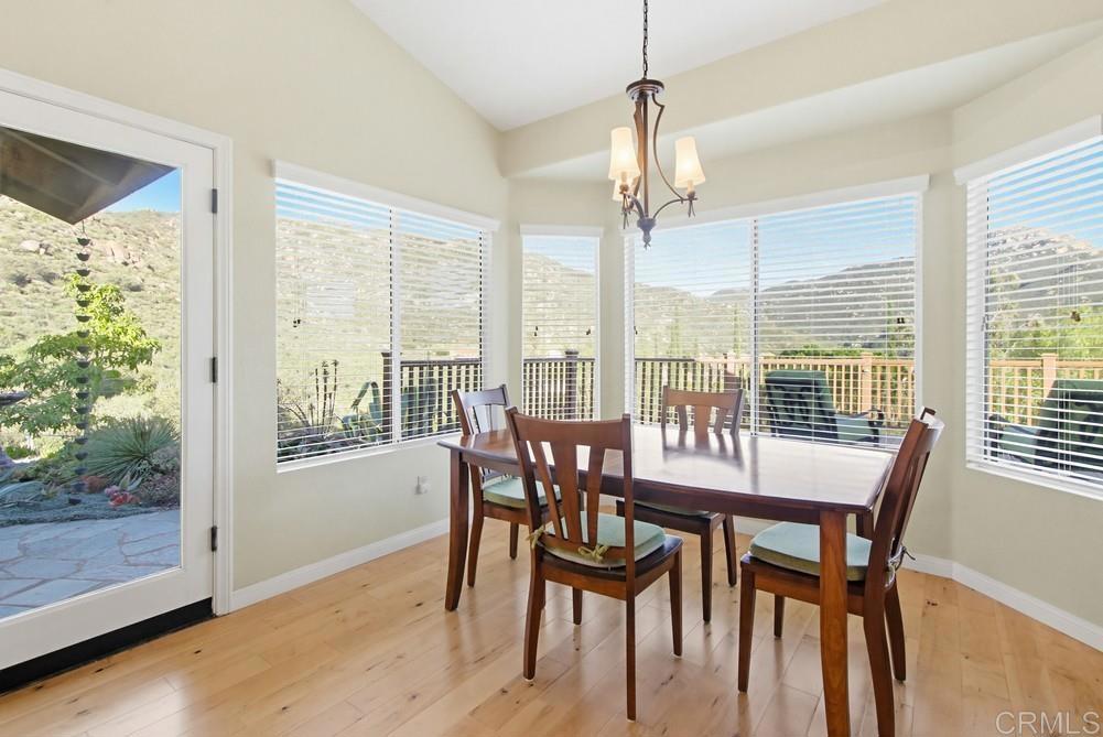 3930 Via Palo Verde Lago Alpine, CA 91901 - Photo 30 of 75 a view of a dining room with furniture large windows and wooden floor