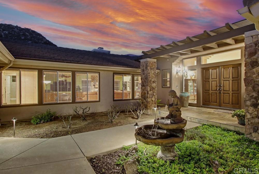 3930 Via Palo Verde Lago Alpine, CA 91901 - Photo 3 of 75 a front view of a house with a fountain